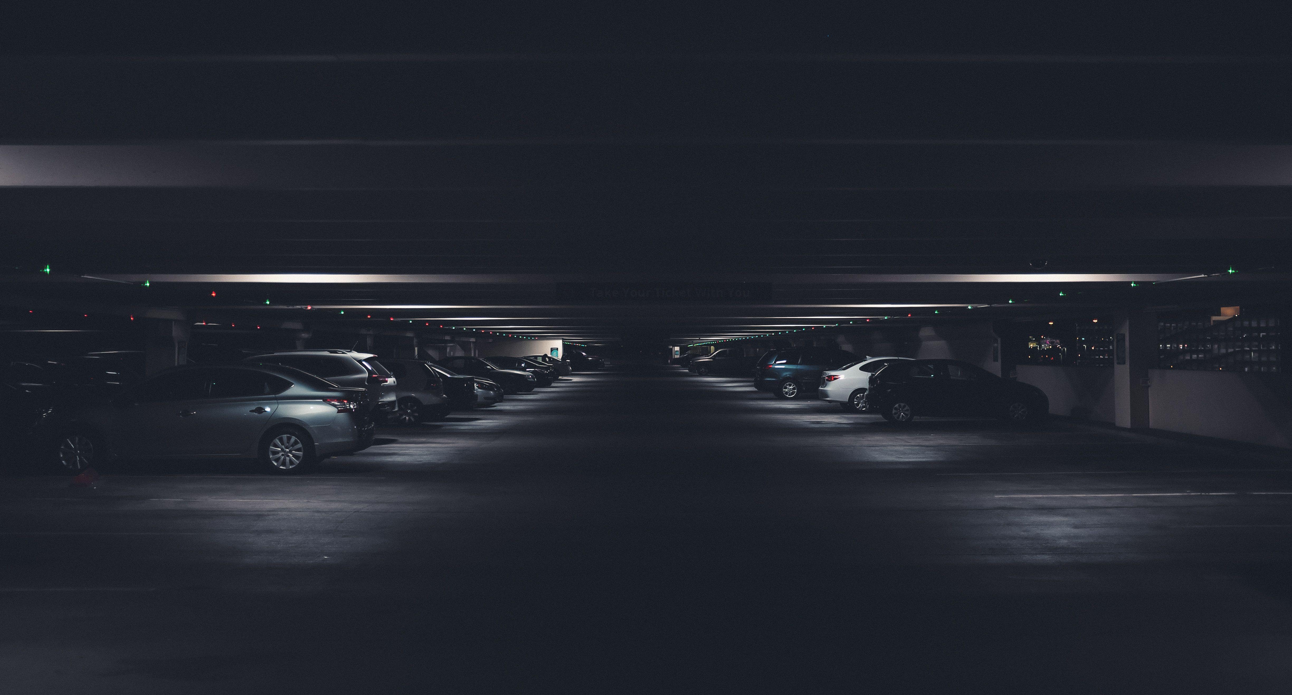 Cars parked in a dimly lit indoor parking garage
